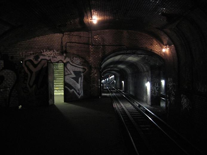 заброшенный тоннель метро с облупившейся штукатуркой